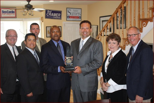 Congressman Heath Shuler accepts the Freedom and Prosperity Award. Shown are Jeff Buczkiewicz, Moroni Mejia, Paul Oldham (rear), Calvin Brodie, Heath Shuler, and Sue and Paul Odom