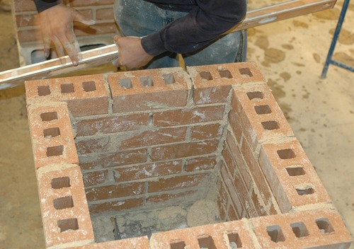 A Kirkwood Masonry student’s hands rapidly work a brick tower during the SkillsUSA competitions at Jones Hall in April 2013.