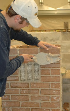 Andy Schlichte of Cedar Rapids nears completion of his masonry competition project in Jones Hall at Kirkwood Community College.