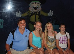 Damian Lang (left) from Lang Masonry and EZ Grout Corporation (MCAA Strategic Partner) with his daughters Amy, Aariah, and Rachel, and Mickey Mouse (center) during the MCAA Closing dinner at the Living Seas Salon at Epcot.