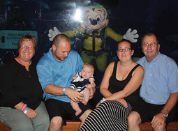 Colleen (left) from Sutter Masonry with Eric Green (left center), Kylee Green (center), Aimee Green (right center) and MCAA Treasurer Mike Sutter (right) get their picture taken with Mickey Mouse during the MCAA Closing dinner at the Living Seas Salon at Epcot.