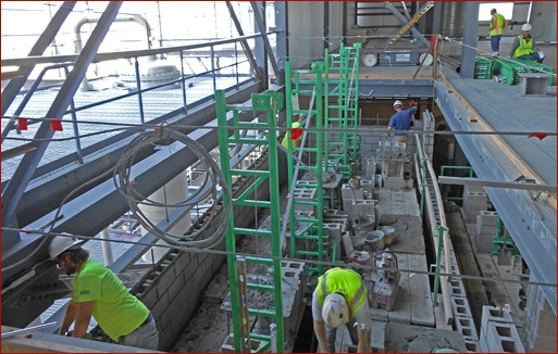 Photo 1:  Seedorff Masonry used Non-Stop scaffolding in a 90-foot-high elevator shaft. The masons outriggers and Inside Corner Arms were used to fully plank the inside of the shaft.