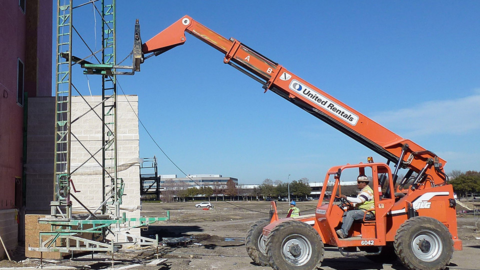 The Swivel Forklift Bar allows your lift driver to grab towers from one wall and land them at the next wall in minutes, and at any angle. Notice the mud sills are nailed to the leveling jacks.